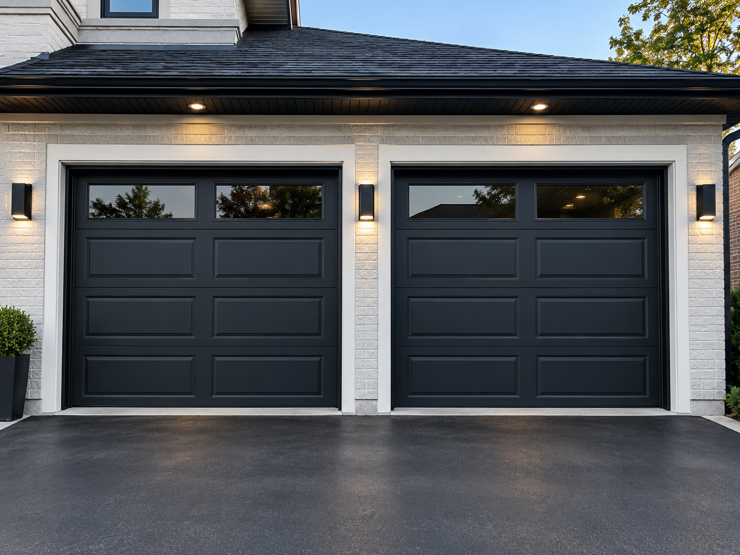Freshly painted black garage doors and white brick exterior